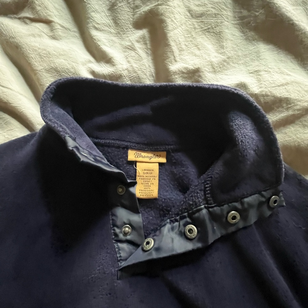 Navy blue Wrangler fleece jacket. Pockets, button up at neck line.